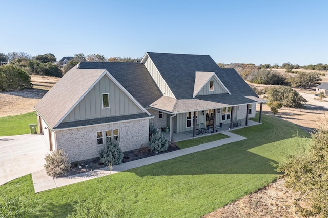 view of front of home with a front yard and a patio area