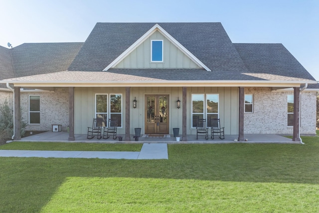 back of house featuring a lawn and a patio area