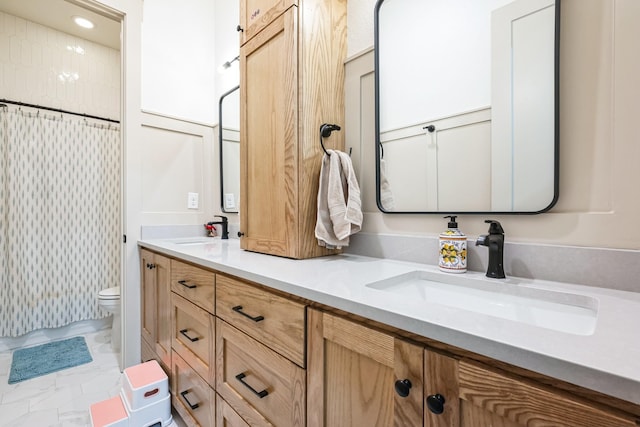 bathroom featuring vanity and toilet