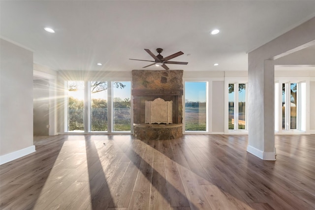 unfurnished living room with wood-type flooring and ceiling fan