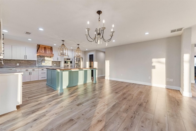 598 Dowell Rd, Rockwall, TX 75032 - kitchen featuring custom range hood, a chandelier, butcher block counters, stainless steel appliances, and recessed lighting