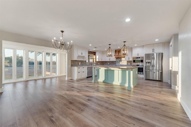 598 Dowell Rd, Rockwall, TX 75032 - kitchen with appliances with stainless steel finishes, a chandelier, recessed lighting, plenty of natural light, and decorative backsplash
