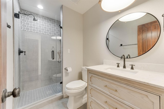 bathroom with vanity, tile patterned flooring, a shower with shower door, and toilet