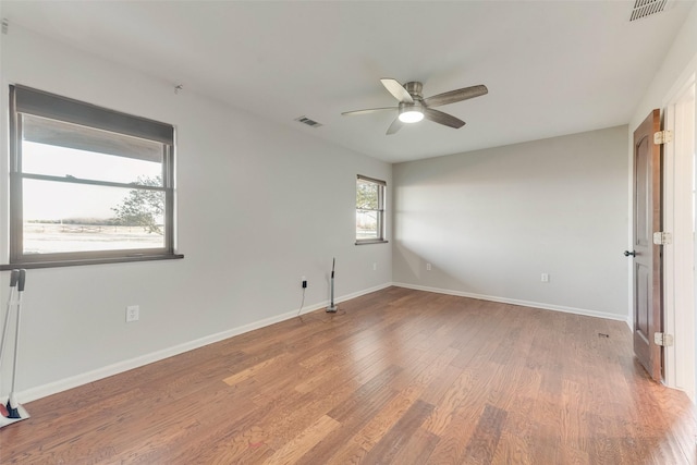 spare room featuring hardwood / wood-style flooring and ceiling fan