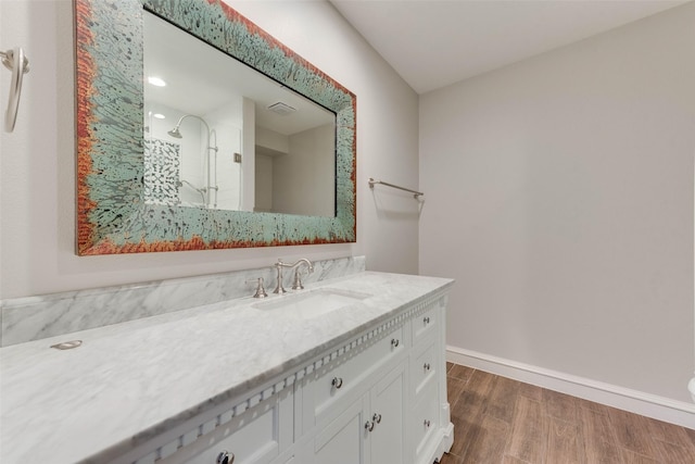 598 Dowell Rd, Rockwall, TX 75032 - full bathroom with a shower stall, wood finished floors, vanity, and baseboards