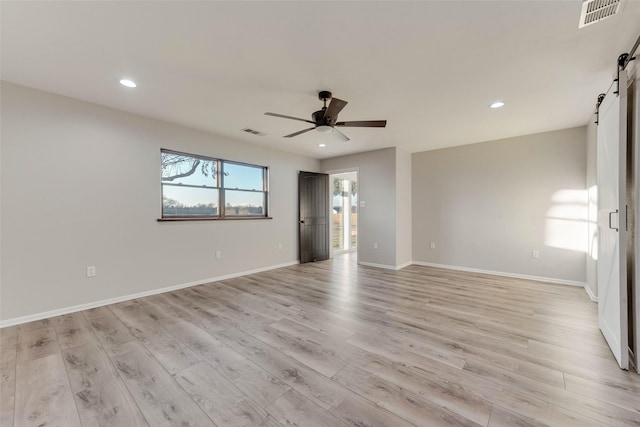 598 Dowell Rd, Rockwall, TX 75032 - unfurnished room featuring a barn door, a ceiling fan, light wood-style floors, recessed lighting, and baseboards