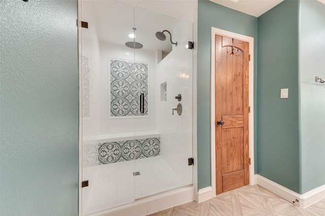 bathroom featuring parquet flooring and an enclosed shower