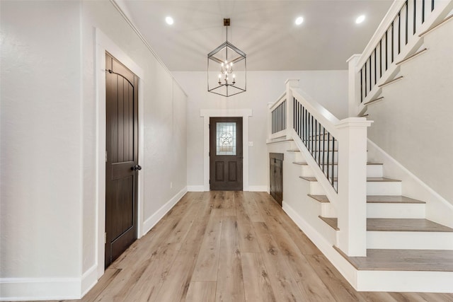 entryway with a chandelier and light hardwood / wood-style flooring