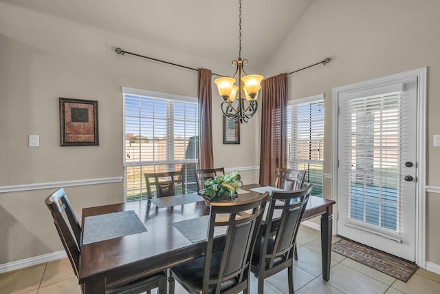 tiled dining space with plenty of natural light, a chandelier, and lofted ceiling