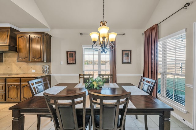 dining space with light tile patterned flooring, vaulted ceiling, and an inviting chandelier