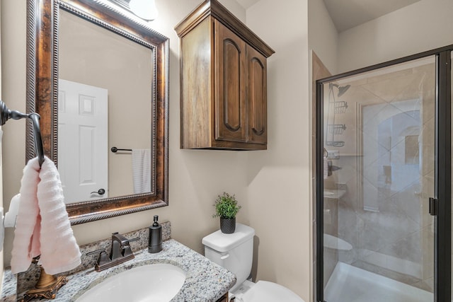 bathroom featuring vanity, toilet, and walk in shower