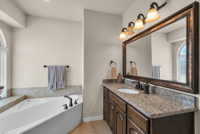 bathroom with tile patterned flooring, vanity, and a tub to relax in