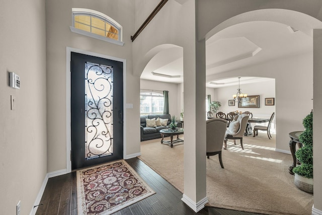 foyer featuring a chandelier and dark wood-type flooring