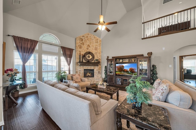 living room with ceiling fan, dark hardwood / wood-style floors, a wealth of natural light, and high vaulted ceiling