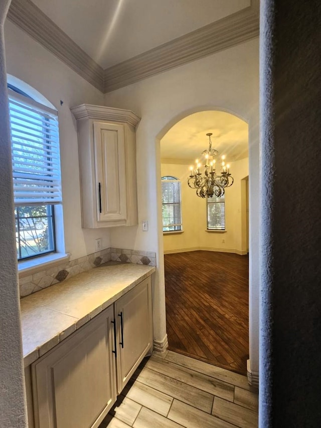 kitchen featuring crown molding and a chandelier