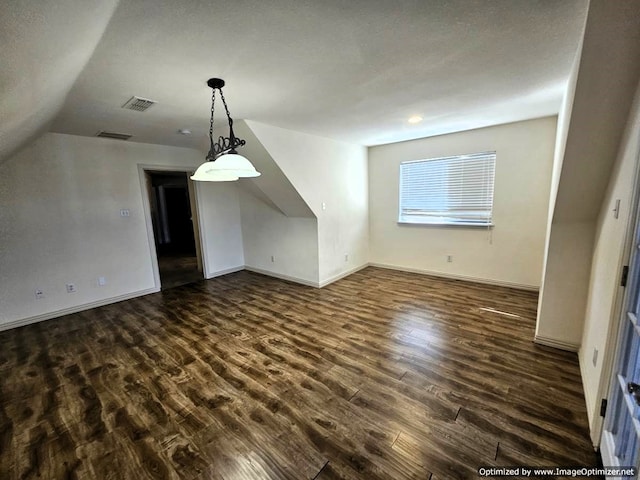 additional living space with lofted ceiling and dark wood-type flooring