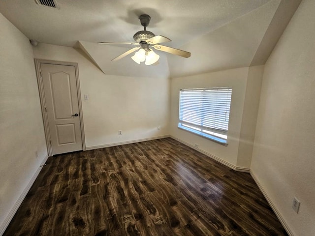 unfurnished room featuring ceiling fan, dark hardwood / wood-style flooring, and lofted ceiling