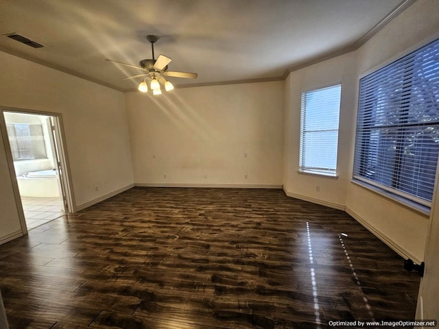 empty room with ceiling fan, dark hardwood / wood-style flooring, and crown molding