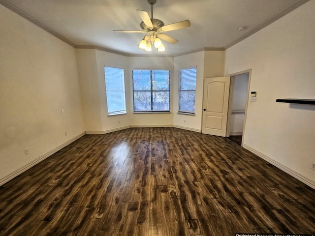 empty room with dark hardwood / wood-style floors, ceiling fan, and crown molding