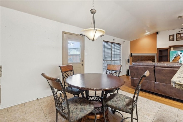 dining room featuring light hardwood / wood-style flooring and lofted ceiling