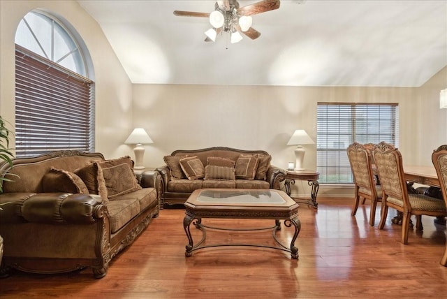 living room featuring hardwood / wood-style floors, a healthy amount of sunlight, and vaulted ceiling