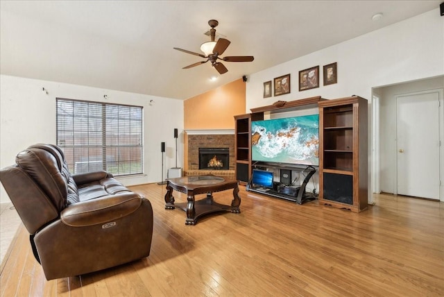 living room featuring ceiling fan, light hardwood / wood-style floors, and vaulted ceiling