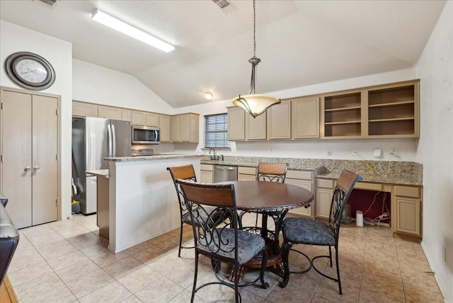 tiled dining space featuring lofted ceiling and sink