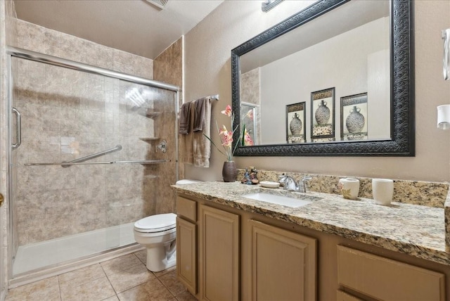 bathroom with tile patterned flooring, vanity, and an enclosed shower