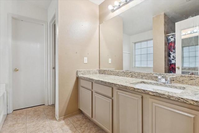 bathroom with tile patterned flooring and vanity