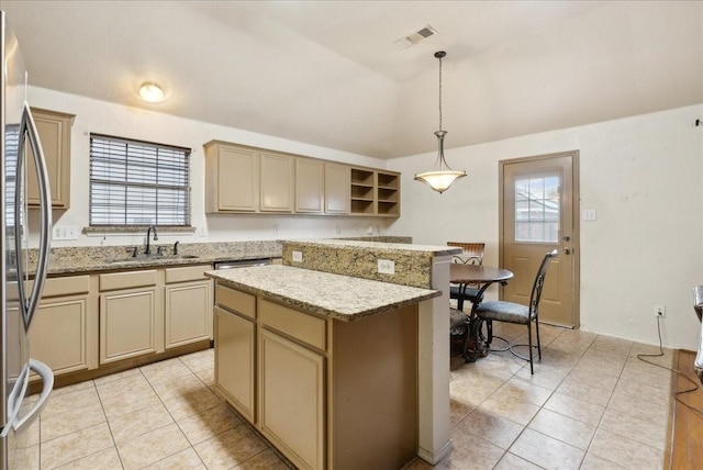 kitchen with a center island, sink, vaulted ceiling, decorative light fixtures, and stainless steel refrigerator