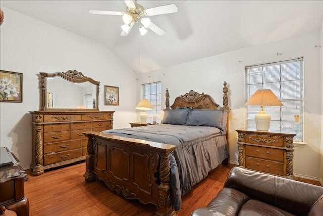 bedroom featuring ceiling fan, wood-type flooring, and vaulted ceiling