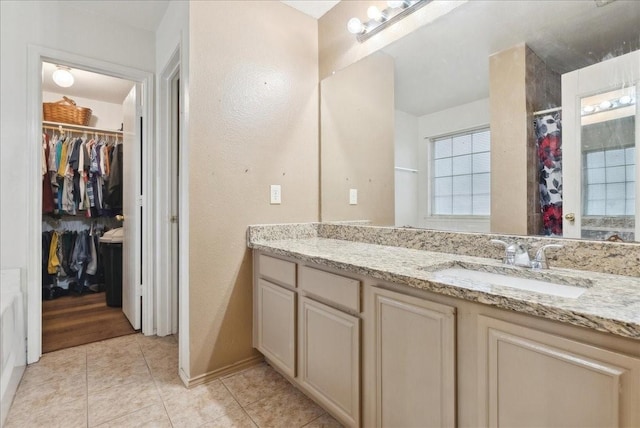 bathroom with tile patterned flooring, vanity, and curtained shower