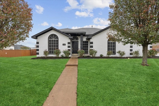 single story home featuring a front lawn