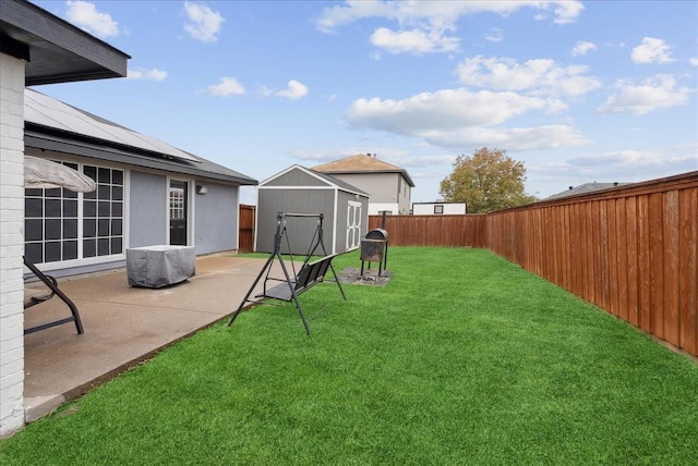 view of yard featuring a patio and a shed