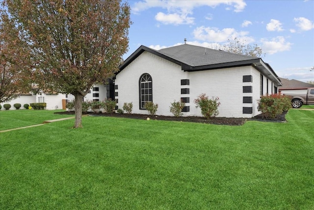 view of property exterior with a lawn