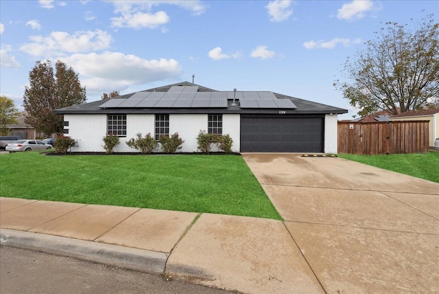 ranch-style house with a front yard and solar panels