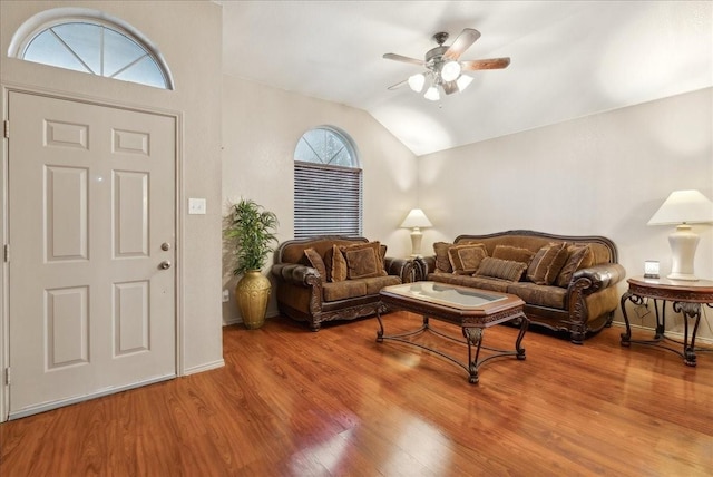 living room featuring hardwood / wood-style flooring, ceiling fan, and lofted ceiling