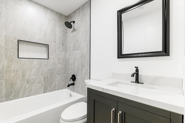 full bathroom featuring toilet, vanity, and tiled shower / bath