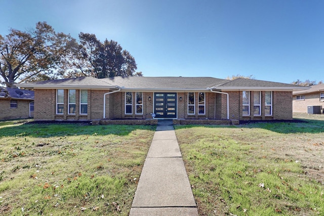 ranch-style house featuring central AC, french doors, and a front yard