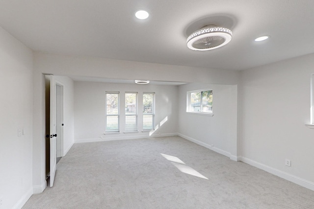 unfurnished room with light colored carpet