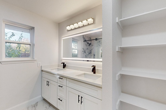 bathroom featuring vanity, tiled shower, and a wealth of natural light