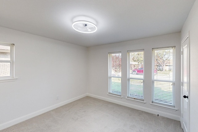 carpeted empty room with plenty of natural light