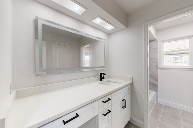 bathroom featuring shower / washtub combination, tile patterned flooring, and vanity