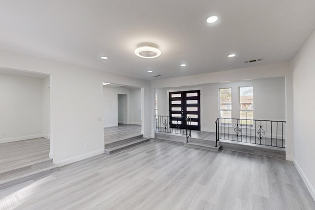 empty room with light hardwood / wood-style flooring