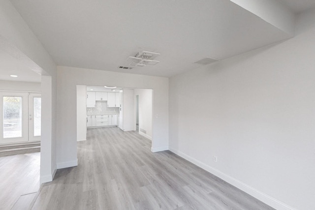 unfurnished living room featuring light hardwood / wood-style floors