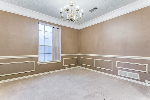 spare room with an inviting chandelier, ornamental molding, and carpet flooring