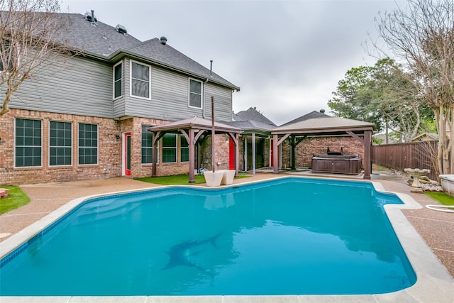 view of swimming pool featuring a gazebo, a hot tub, and a patio area