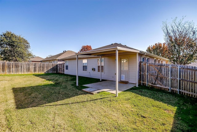 back of property with a patio and a lawn