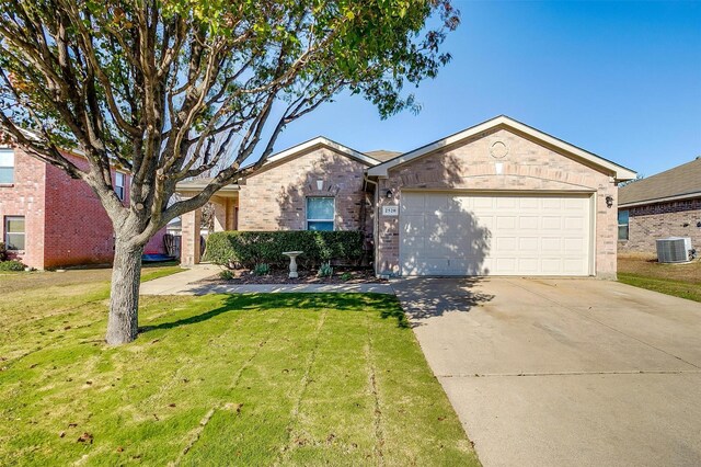 ranch-style house featuring a front yard, central AC, and a garage