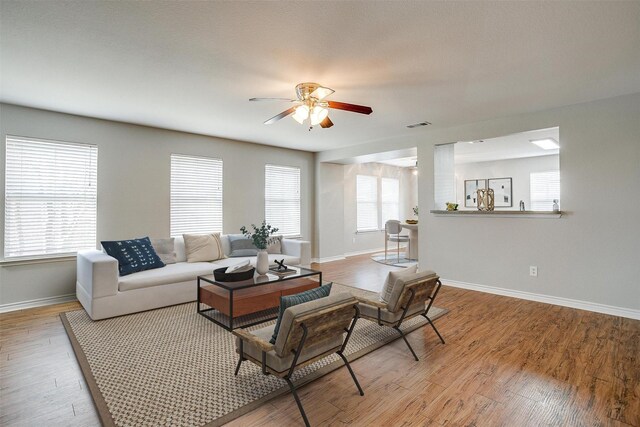 unfurnished living room with ceiling fan and light wood-type flooring